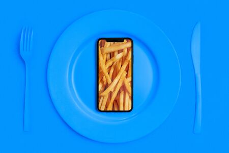 Order food online, food delivery. Call and bring food home. Smartphone with chips on the screen,...