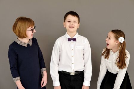 best school friends: girls and boys. Girlfriends rejoice and laugh at the boy. Portrait of...