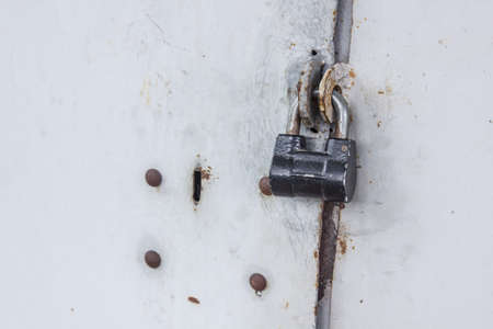 the lock is locked on the old doorの写真素材