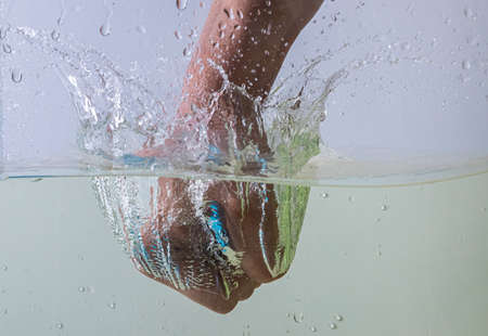 fist beats on the water splashes and drops fly away. detection of emotionsの写真素材