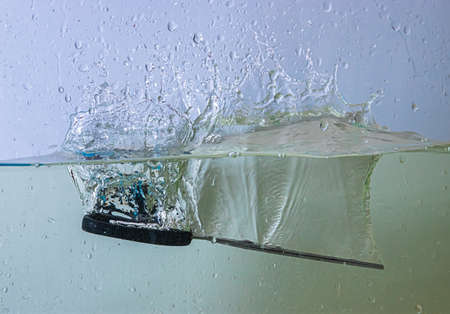 scissors fall into the water. sprays, drops and bubblesの写真素材