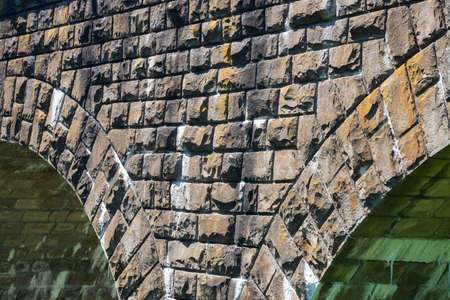 the old railway bridge is built of stone. historic building usedの写真素材