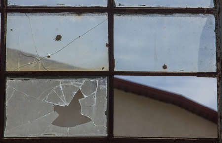 broken glass in the window. background sky, danger, devastationの写真素材