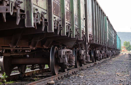 Old rusty railway cars stand on the tracks of the stationの写真素材