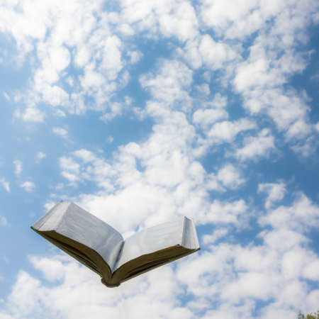 blank white open book on sky backgroundの写真素材
