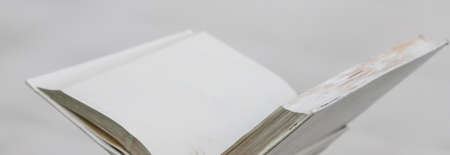 blank white open book on a uniform background
