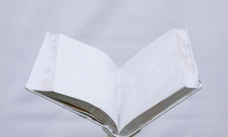 blank white open book on a uniform background