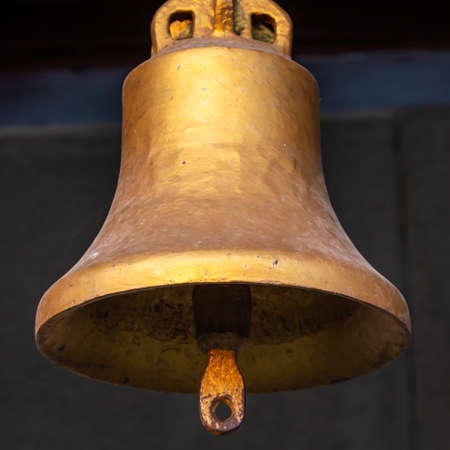Copper old vintage bell. Decor concept element in the interior of a deck, cabin of a ship, restaurant, room, house, decorated on a marine themeの写真素材