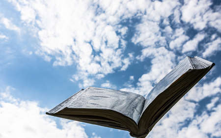 blank white open book on sky backgroundの写真素材