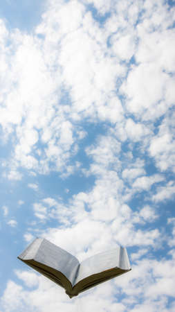 blank white open book on sky backgroundの写真素材