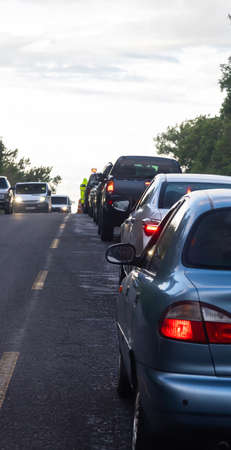 traffic jams on the road are associated with the repair of the roadway. eveningの写真素材