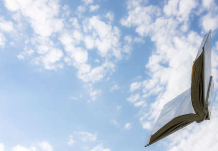 blank white open book on sky backgroundの写真素材