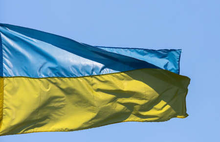 flag and coat of arms of Ukraine on sky backgroundの写真素材