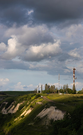 TV tower, mobile phone tower over countryside on sky background with cloudsの写真素材