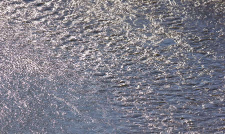 Fast river water background with waves and ripple pattern.