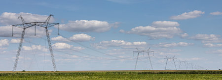 Overhead power line, power transmission line, support of high-voltage overhead power line, against the background of the sky with clouds.の写真素材