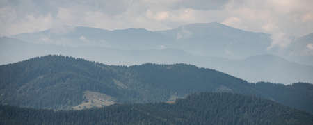 mountain slopes in the Ukrainian Carpathians. mountain tops and forests on a background of blue sky.の写真素材