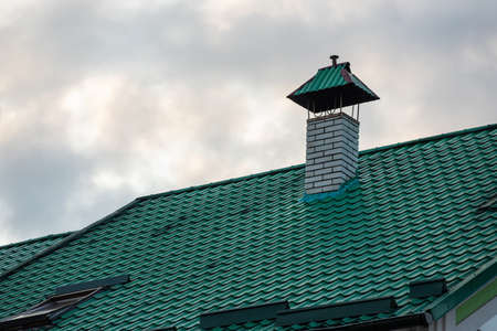 roof covered with metal tiles, roofing, wooden house.の写真素材