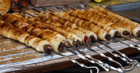 grilled sausages, vegetables, salads on the counter in the food court. street food.の写真素材