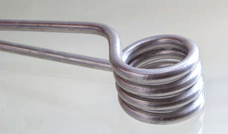 Immersion heater with a shadow on a light background.