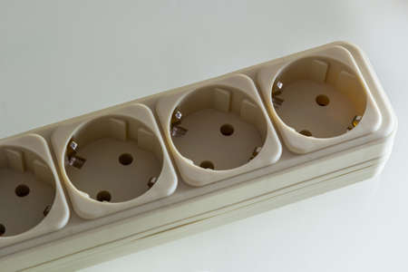 Close up of extension power strip isolated on white.の写真素材