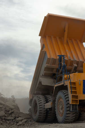 Large mining dump truck. Transport industry. Extraction of stone in an open pit.の写真素材