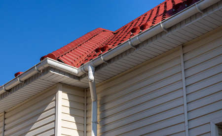 Building Modern House Construction with metal roof corner, rain gutter system and roof protection...