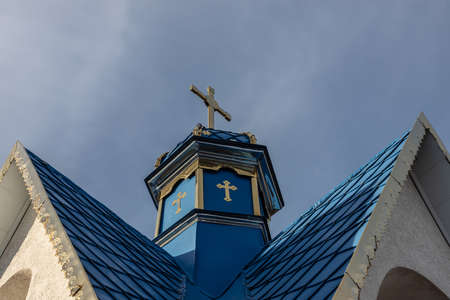 Close-up of a Cross on a Christian church on blue background.の写真素材