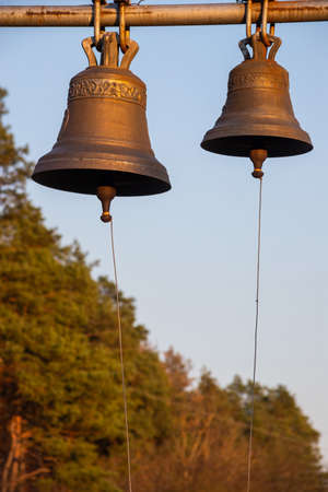 Large Church bell hanging outside. Close-up view of metal orthodox church bell.の写真素材