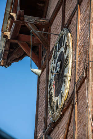 clock face on old wooden tower close up. Ukraine, Chortkiv.