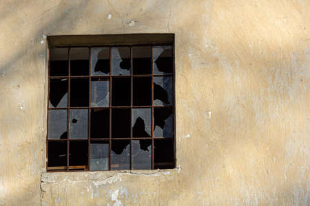 An old vintage wooden window with peeling paint oh frames needed to be repaired or replaced.