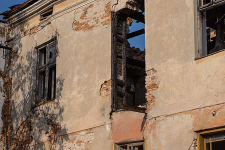 An old vintage wooden window with peeling paint oh frames needed to be repaired or replaced.