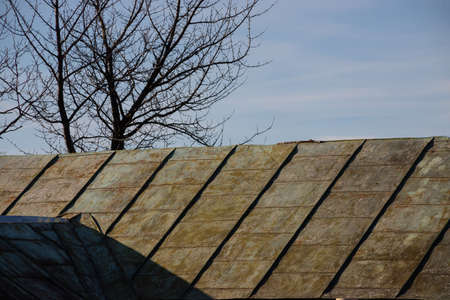 Roof and chimney from an old house - brick and metallic texture.