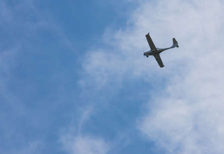 small plane flying low in the sky with space for text.