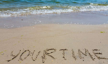 Handwriting word your time written in the sand.の写真素材