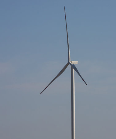 wind mill or also wind-turbine on wind farm in rotation to generate electricity energy on outdoor...