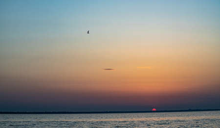 Beautiful red and orange sunset over the lake.の写真素材