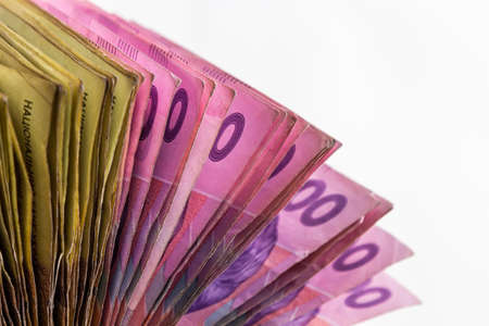 Ukrainian paper money is laid out on a blue background. 200 hryvnia banknotes.