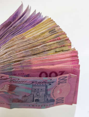 Ukrainian hryvnias bills lies isolated on white background with copy space stacked in fan close up....