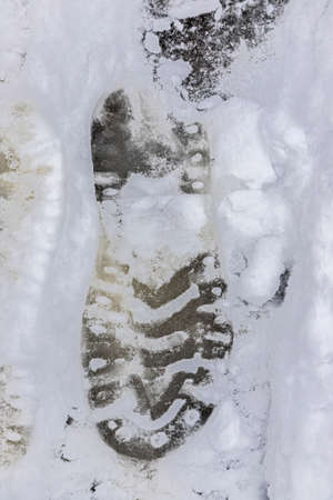 Top view of the footprint of shoes boots on fresh snow. The winter season.の写真素材