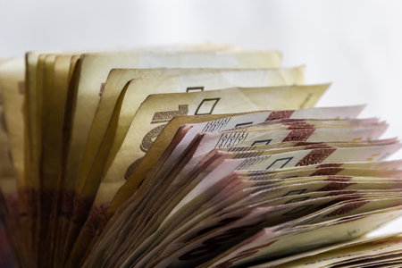 Ukrainian hryvnias bills lies isolated on white background with copy space stacked in fan close up. Payday time concept or financial operations.の写真素材