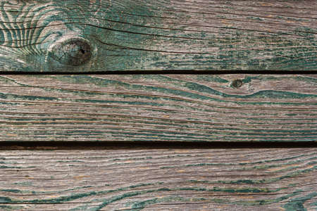 Wooden background, old wooden wall, painted blue, with slits and nails.