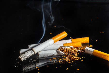 Cigarette smoking closeup isolated on balck background. no smoking concept.
