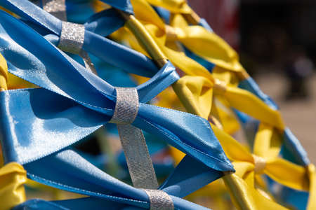 Yellow-blue, colors of the Ukrainian national flag, fabric ribbon intertwined on the frame. Symbol of the celebration of Ukraine's independence.の写真素材