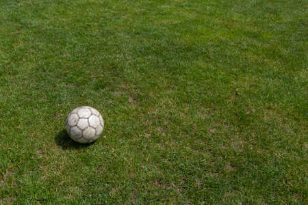 Soccer ball on green grass of football field with copy space.の写真素材