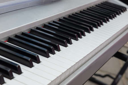 close up of piano keys. close frontal view, black and white piano keys, viewed from above.