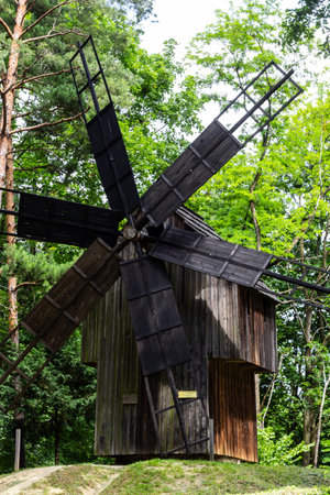 An old wooden mill in a Ukrainian village. Historical building in the forest close-up.