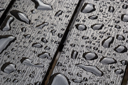 abstract background drops of rain water on a wooden table.の写真素材