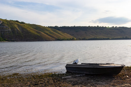 the boat stands on the bank of the river. Means of transportation on water.の写真素材