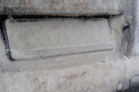 snow and mud covered car license plate. snow and mud covered the car license plate. Vehicle registration plate is not read.の写真素材